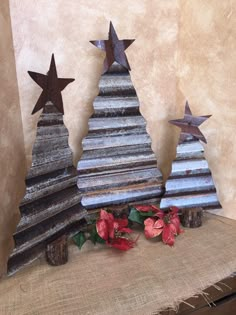 three metal christmas trees sitting on top of a table