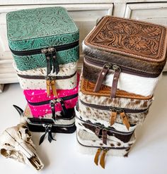 "These big jewelry boxes are so cute and are great for travel or a statement piece on your vanity/ dresser.  They hold rings, bracelets, earrings and necklaces! These also make GREAT gifts! 🎁  approximate size Length: 6\" Width: 6\" Thickness: 3\" Genuine cowhide Genuine leather  Zippered closure ** PLEASE READ ** * tan + white cowhide and brown + white cowhide jewelry boxes have cowhide on bottom, sides and bottom - you will get a jewery box from that color group  * tan and brown tooled top ha Cowhide Jewelry Case, Western Jewelry Box, Classy Cowgirl, Custom Leather Belts, Leather Cosmetic Bag, Western Gifts, Cowgirl Accessories, Leather Tooling Patterns, Big Jewelry