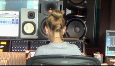 a woman is sitting in front of some sound equipment