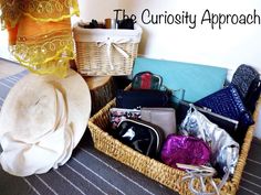 a wicker basket filled with lots of purses and other items next to a wall