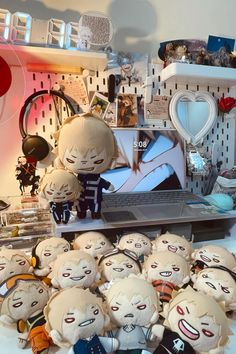 a bunch of stuffed animals sitting on top of a desk