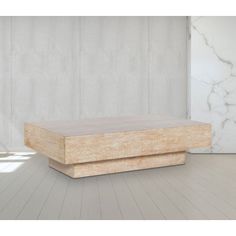 a wooden box sitting on top of a hard wood floor next to a white wall