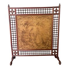 an ornately decorated metal and wood frame with a painting on the back side,