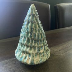 a small ceramic cone sitting on top of a wooden table