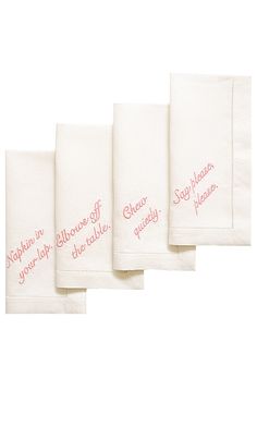 four white towels with pink writing on them