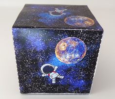 an outer space themed box is shown with the astronaut on it's side and stars in the background