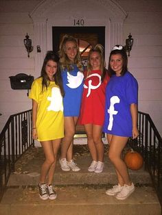 four girls dressed in halloween costumes standing on the front steps of a house with pumpkins