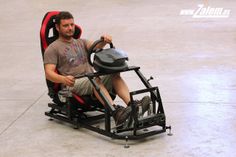 a man sitting in a chair with a steering wheel