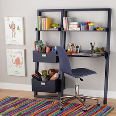 a child's desk with bookshelf and storage bins on the bottom shelf