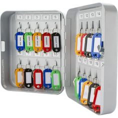 an open storage box with keys and keychains in it