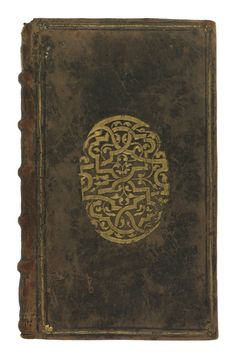 an old book with gold designs on it