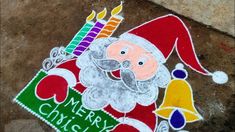 a chalk drawing of santa claus holding a bell with candles on it's chest