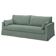 a green couch with two pillows on it