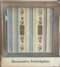 two decorative switchplates with pink flowers on them in a plastic package for sale