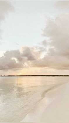 the beach is empty and there are clouds in the sky