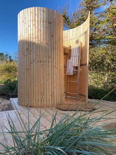 a wooden structure with a ladder in the middle and a towel hanging on it's side