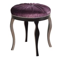 an upholstered stool with purple velvet and metal trimmings on the legs