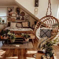 a bedroom with a bed, hanging chair and potted plants on the floor in front of it