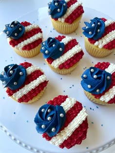 cupcakes decorated with red, white and blue icing are on a plate