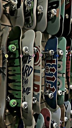 many skateboards are lined up on the wall and ready to be used for display