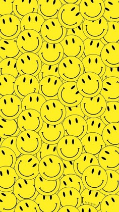 a yellow background with many smiley faces drawn on the front and back of each face