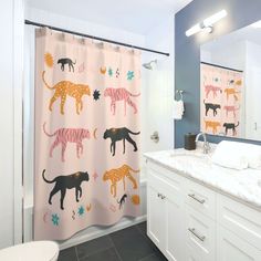 a bathroom with two shower curtains and a sink