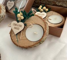 two wooden slices with candles in them sitting next to each other on top of a table