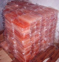 a stack of plastic bags sitting on top of a wooden floor next to a wall