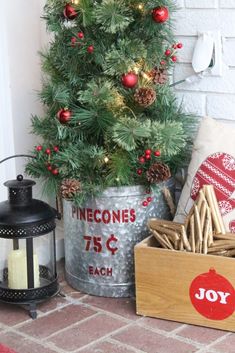 a small christmas tree in a metal bucket