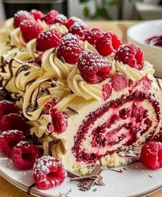 there is a cake with raspberries on it