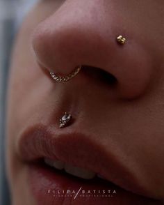 a woman's nose with a gold nose piercing