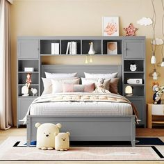 a bedroom with a bed, bookshelf and stuffed animals