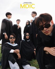 a group of people in black robes and sunglasses