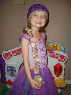 This is my Rapunzel inspired wig hat. It is a purple hat with a long blonde braid in the back. It is braided with pink and purple ribbon. Then I add flowers and rhinestones for that special touch! I can also do this hat in yellow yarn hair. Just put in notes to seller when you checkout.  My daughter is 4 years old and the 20 inch braid goes down to her bottom, the 24 inch goes to the back of her knees, and the 28 inch goes to the back of her calves.  If you would like a different length, just pu Blonde Halloween Costumes, Halloween Costume Hats, Autumn Hat, Rapunzel Costume, Rapunzel Dress, Yellow Yarn, Couple Halloween Costumes For Adults, Purple Hat, Yarn Hair