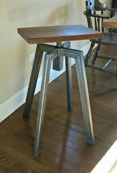 two chairs and a table in a room with hard wood flooring on the ground