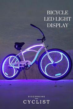 a bicycle is shown with blue lights on the front and back wheel, as well as an advertisement for cyclist