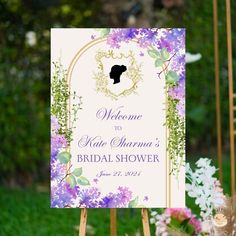 a welcome sign with purple flowers on it