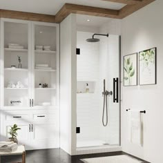 a bathroom with white cabinets and black tile flooring is pictured in this image, it has a walk - in shower