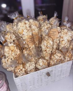 a basket filled with lots of popcorn sitting on top of a table