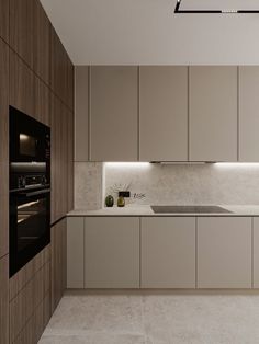 a kitchen with white counter tops and beige cabinets