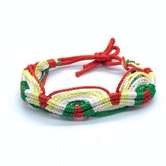 MADE WITH LOVE - Handmade wristband with the Rastafarian colours: green, yellow and red. Unique Jamaican bracelet with an adjustable drawstring closure. Adjust this Rasta cord bracelet by tying the cords into a knot at the desirable length (you can even wear it as an ankle bracelet). It measures about 7 inches adjustable up to 11inches. With its black braided macrame band, this bracelet is very durable, so perfect for the beach or to wear while travelling. NATURAL CORD JEWELRY - Waxed cotton bracelets for men and women. Woven friendship bracelets will add some colour to your wrist! QUALITY CRAFTSMANSHIP - High quality, handcrafted jewelry for women and men. Accessorize your outfit with a boho friendship bracelet that is both long-lasting and stunning to behold. Incorporating bohemian desig Pot Leaf Bracelet, Macrame Band, Woven Friendship Bracelets, Hippie Braids, Braided Macrame, Hippie Accessories, Cotton Bracelet, Cord Jewelry, Braided Rope