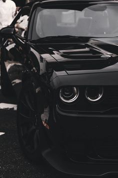 the front end of a black sports car