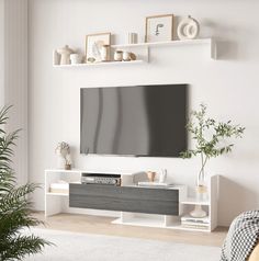 a flat screen tv mounted to the side of a white wall in a living room