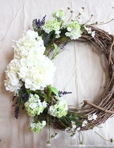 a wreath with white flowers and greenery