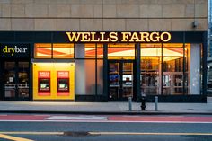 a store front with the words wells fargo written on it's windows at night