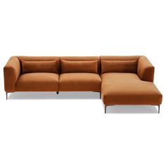 an orange sectional sofa sitting on top of a white floor next to a footstool