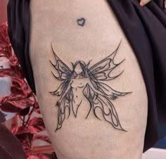 a woman's thigh with a tattoo design on it