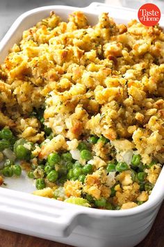 a casserole dish with peas and stuffing in it