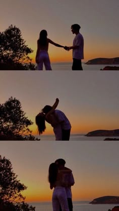 two people standing next to each other in front of the ocean with trees and sunset behind them