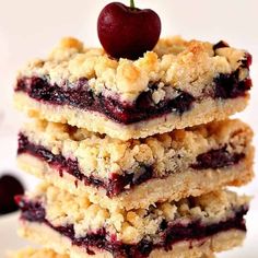 a stack of crumbly bars with a cherry on top